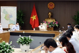 Phó Thủ tướng Chính phủ Vũ Đức Đam, Trưởng ban Chỉ đạo Quốc gia phòng, chống dịch COVID-19 chủ trì cuộc họp trực tuyến. (Ảnh: Phạm Kiên/TTXVN)