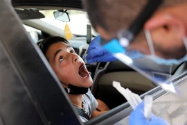 Nhân viên y tế lấy mẫu xét nghiệm COVID-19 cho người dân tại Beit Shemesh, Israel, ngày 18/7. (Ảnh: THX/ TTXVN)