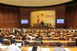 Đại biểu Quốc hội thông qua toàn văn Luật Mặt trận Tổ quốc Việt Nam (sửa đổi). (Ảnh: Phương Hoa/TTXVN)