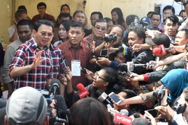 Thị trưởng đương nhiệm của Jakarta Basuki Tjahaja Purnama (trái) trả lời báo giới sau khi bỏ phiếu tại thủ đô ngày 15/2. (Nguồn: AFP/TTXVN)