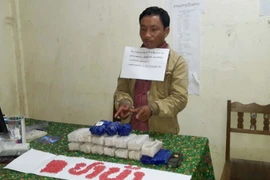 Đối tượng Thạo Thay Vàng và tang vật vụ án. (Ảnh: Trịnh Duy Hưng/TTXVN)