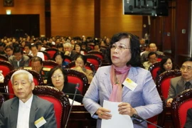 Bộ trưởng Bộ Lao động-Thương binh và Xã hội Phạm Thị Hải Chuyền trả lời các câu hỏi của đại biểu Quốc hội. (Ảnh: Lâm Khánh/TTXVN)