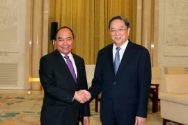 Thủ tướng Nguyễn Xuân Phúc hội kiến với Chủ tịch Chính hiệp toàn quốc Trung Quốc Du Chính Thanh. (Ảnh: Thống Nhất/TTXVN)