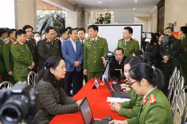Thiếu tướng Nguyễn Duy Ngọc, Thứ trưởng Bộ Công an và các đại biểu thăm quan việc triển khai của các đơn vị công an quận cấp Căn cước công dân lưu động. (Ảnh: Doãn Tấn/TTXVN)