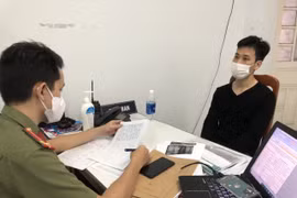 Đối tượng Phạm Văn Sơn (bên phải) khai nhận tại cơ quan công an. (Ảnh: TTXVN phát)
