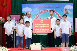 Chủ tịch nước Nguyễn Xuân Phúc tặng quà cho Trung tâm Nuôi dưỡng trẻ khuyết tật Hà Nội. (Ảnh An Đăng/TTXVN) 