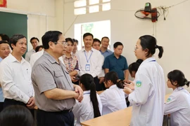 Thủ tướng Phạm Minh Chính động viên, khuyến khích học sinh Trường THPT Yên Lập, huyện Yên Lập. (Ảnh: Dương Giang/TTXVN) 