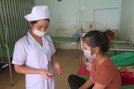 Bác sỹ hướng dẫn bệnh nhân lao uống thuốc tại Trung tâm Y tế huyện Đăk Hà, tỉnh Kon Tum. (Ảnh: Dư Toán/TTXVN)