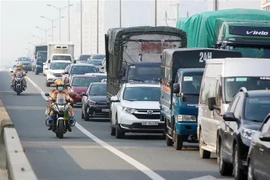 Lực lượng cảnh sát giao thông sử dụng xe môtô đặc chủng liên tục gọi loa, nhắc nhở các xe đi đúng hàng lối, tuân thủ điều tiết giao thông. (Ảnh: Phạm Kiên/TTXVN)