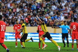 Cầu thủ Malaysia ăn mừng khi có bàn thắng gỡ hòa 2-2. (Ảnh: Tuấn Anh/TTXVN)
