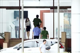 Lực lượng chức năng tới Trụ sở Bộ Y tế thực hiện việc khám xét nơi làm việc của cựu Bộ trưởng Bộ Y tế Nguyễn Thanh Long. (Ảnh: Phạm Kiên/TTXVN)