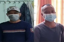 Bị can Nguyễn Văn Nhơn (bên trái) và Huỳnh Văn Lấm bị khởi tố, bắt giam về hành vi 'Chống người thi hành công vụ.' (Ảnh: TTXVN phát)