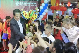 Đại sứ Đặng Minh Khôi trao đèn lồng Trung Thu cho các em thiếu nhi Việt Nam và Nga tham gia đón Trung Thu tại Incentra. (Ảnh: Trần Hiếu/TTXVN)