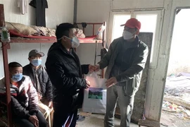 Đại sứ Nguyễn Thành Vinh tặng quà Tết cho đại diện một số công nhân tại công trường Raffinerie d’Alger. (Ảnh: Tấn Đạt/TTXVN)