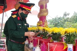 Đoàn lãnh đạo Bộ Chỉ huy Quân sự tỉnh Quảng Trị dâng hương các hài cốt liệt sỹ được quàn tại Nhà bia ghi danh liệt sỹ xã Vĩnh Sơn. (Ảnh: Nguyên Lý/TTXVN)