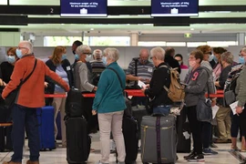 Hành khách chờ đợi tại quầy làm thủ tục ở sân bay quốc tế Sydney (Australia), ngày 19/4/2021. (Ảnh: AFP/TTXVN)