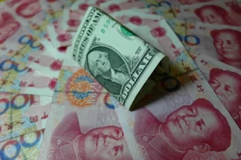 Đồng nhân dân tệ Trung Quốc (màu đỏ) và đồng USD (màu xanh). (Nguồn: Kyodo/TTXVN)