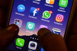 Biểu tượng Facebook (thứ 2, trái, hàng giữa) và Whatsapp (thứ 2, phải, hàng giữa) trên màn hình điện thoại. (Ảnh: AFP/TTXVN)