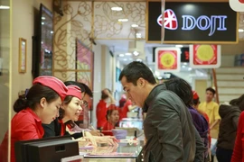 Khách hàng đang giao dịch vàng miếng. (Ảnh: Đức Duy/Vietnam+)