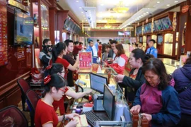 Khách hàng đang giao dịch vàng miếng. (Ảnh: Đức Duy/Vietnam+)