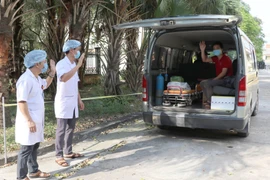 Các y bác sỹ Bệnh viện Đa khoa huyện Kim Sơn chào tạm biệt bệnh nhân nhiễm Covid-19 cuối cùng điều trị tại Ninh Bình được xuất viện. (Ảnh: Thùy Dung/TTXVN)