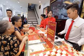 Khách mua bán vàng tại Công ty kinh doanh vàng bạc Mạnh Hải. (Ảnh: Trần Việt/TTXVN)