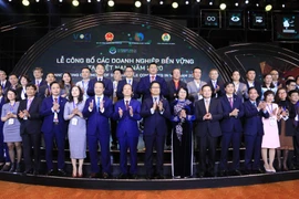 Phó Chủ tịch nước Đặng Thị Ngọc Thịnh và các đại biểu chụp ảnh chung cùng các doanh nghiệp được vinh danh. (Ảnh: Thành Đạt/TTXVN)