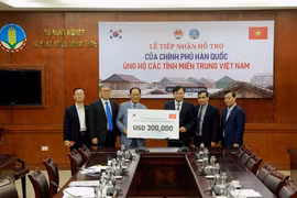 Ông Park Noh-Wan, Đại sứ Hàn Quốc tại Việt Nam trao tượng trưng gói hỗ trợ 300.000 USD cho Ủy viên Ban Chỉ đạo Trung ương về Phòng, chống thiên tai Nguyễn Hoàng Hiệp. (Ảnh: Vũ Sinh/TTXVN)
