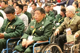 Các đồng chí thương binh, bệnh binh tại buổi gặp mặt. (Ảnh: PV/Vietnam+) 
