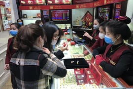 Khách hàng giao dịch vàng miếng. (Ảnh: Đức Duy/Vietnam+)