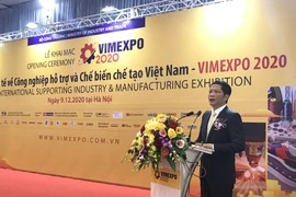 Bộ trưởng Bộ Công Thương Trần Tuấn Anh phát biểu tại Triển lãm quốc tế về công nghiệp hỗ trợ và chế biến, chế tạo sáng 9/12. (Ảnh: Đức Duy/Vietnam+)
