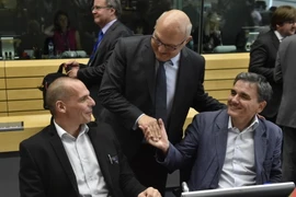 Bộ trưởng Tài chính, Kinh tế và Thương mại Pháp Michel Sapin (giữa) và Bộ trưởng Tài chính Hy Lạp Yanis Varoufakis trước cuộc họp. (Nguồn: AFP/TTXVN)