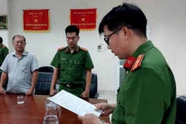 Cán bộ Cơ quan Cảnh sát Điều tra - Công an tỉnh Bà Rịa-Vũng Tàu đọc lệnh khởi tố bị can đối với ông Phạm Minh An. (Ảnh: Công an cung cấp)