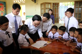 Bộ trưởng Phùng Xuân Nhạ với thầy trò Trường tiểu học Tân Hóa, huyện Minh Hóa, tỉnh Quảng Bình. (Ảnh: Văn Tý/TTXVN)