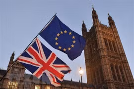 Cờ Anh (phía dưới) và cờ EU (phía trên) tại thủ đô London, Anh. (Ảnh: AFP/TTXVN)
