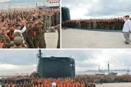 Nhà lãnh đạo Kim Jong-un (phải- phía trên) và các binh sĩ Triều Tiên mừng thành công vụ phóng thử tên lửa đạn đạo "Pukguksong" từ tàu ngầm ngày 25/8. (Nguồn: YONHAP/TTXVN)