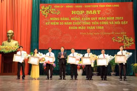Chủ tịch UBND tỉnh Vĩnh Long Lữ Quang Ngời trao Huân chương Lao động hạng Ba của Chủ tịch nước cho các cá nhân. (Ảnh: Phạm Minh Tuấn/TTXVN.)