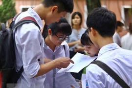 Thí sinh xem lại bài sau khi thi trung học phổ thông quốc gia 2017. (Ảnh: Quý Trung/TTXVN)