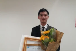 Em Đinh Anh Tú nhận giải thưởng tại Hà Nội. (Ảnh: PM/Vietnam+)