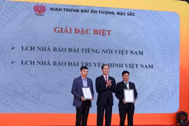 Chủ tịch nước Trần Đại Quang trao giải đặc biệt gian trưng bày ấn tượng, đặc sắc cho 2 đơn vị Đài truyền hình Việt Nam VTV và Đài tiếng nói Việt Nam VOV. (Ảnh: Minh Sơn/Vietnam+) 