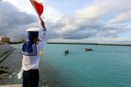 Chiến sĩ đảo Đá Tây A làm nhiệm vụ dẫn thuyền cập cảng. (Ảnh: Danh Lam/TTXVN)