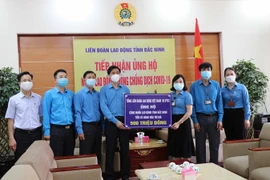 Liên đoàn Lao động tỉnh Bắc Ninh tiếp nhận ủng hộ cho công nhân, người lao động từ Tổng Liên đoàn Lao động Việt Nam và VTV3, Đài Truyền hình Việt Nam. (Ảnh: Thanh Thương/TTXVN)