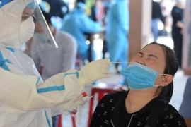 Nhân viên y tế lấy mẫu xét nghiệm COVID-19. (Ảnh: Văn Dũng/TTXVN)