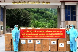 Lãnh đạo Sở Ngoại vụ và Sở Y tế Hà Giang tiếp nhận vật tư y tế do Trung Quốc trao tặng. (Ảnh: Minh Tâm/TTXVN)