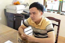 Đối tượng Nguyễn Tiến Sỹ tại cơ quan điều tra. (Ảnh: TTXVN phát)