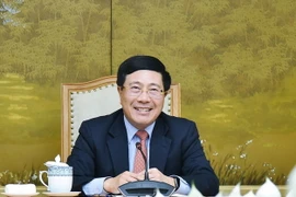 Phó Thủ tướng, Bộ trưởng Bộ Ngoại giao Phạm Bình Minh tại buổi điện đàm với Đặc phái viên Tổng thống Hoa Kỳ về biến đổi khí hậu John Kerry. (Ảnh: TTXVN)