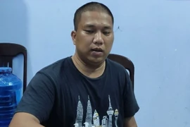 Đối tượng Nguyễn Quốc Nhựt tại cơ quan điều tra. (Ảnh: TTXVN phát)