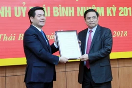 Trưởng Ban Tổ chức Trung ương Phạm Minh Chính (phải) trao quyết định cho ông Nguyễn Hồng Diên. (Ảnh: Thế Duyệt/TTXVN)