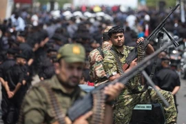 Các tay súng Palestine trung thành với phong trào Hồi giáo Hamas trong cuộc diễu binh tại thành phố Gaza ngày 26/7. (Nguồn: AFP/TTXVN)