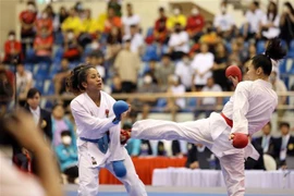 Vận động viên Nguyễn Thị Ngoan (Việt Nam, đai đỏ) thi đấu lấn lướt trong trận chung kết Kumite hạng dưới 61 kg gặp Dea Deavina (Indonesia, đai xanh). (Ảnh: Thanh Tùng/TTXVN)